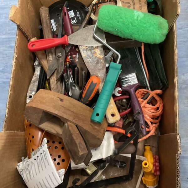 Tray of mixed hand tools and garden implements for DIY projects.