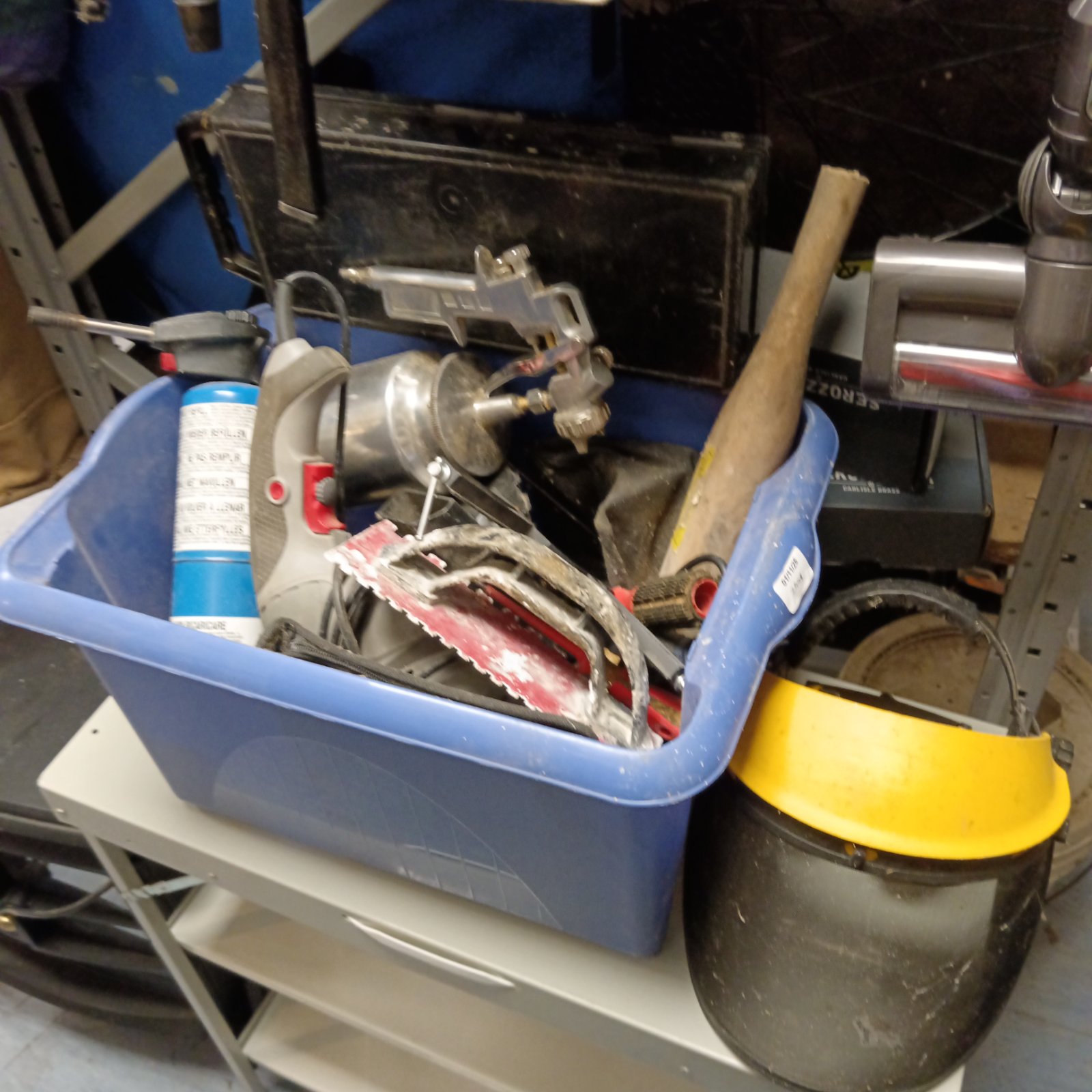 Blue tub of mixed workshop tools with air sprayer and face shield