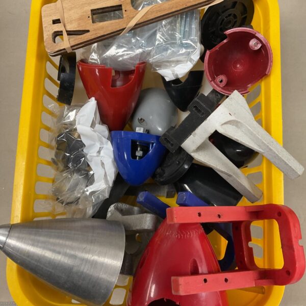 Yellow basket of red, blue and silver propeller spinners and engine mounts