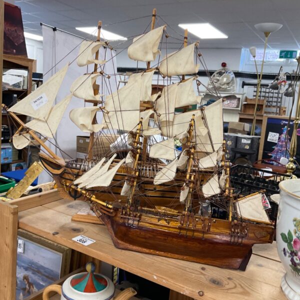 Detailed vintage model sailing ship with intricate rigging.