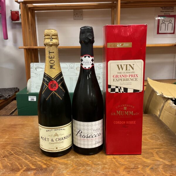 Moët & Chandon Brut Impérial and Plaza Centro Prosecco bottles beside Mumm Cordon Rouge presentation box