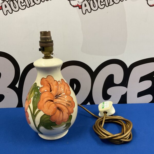 Moorcroft table lamp with hibiscus design, side view.