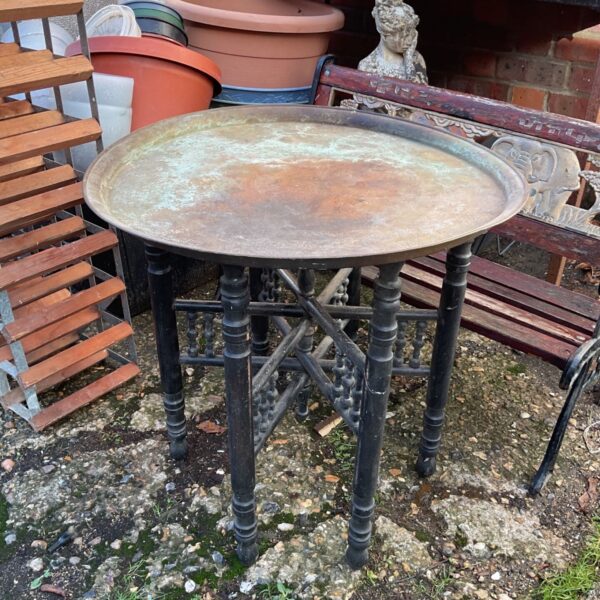 Moorish brass charger folding table with turned wooden legs and patinated top