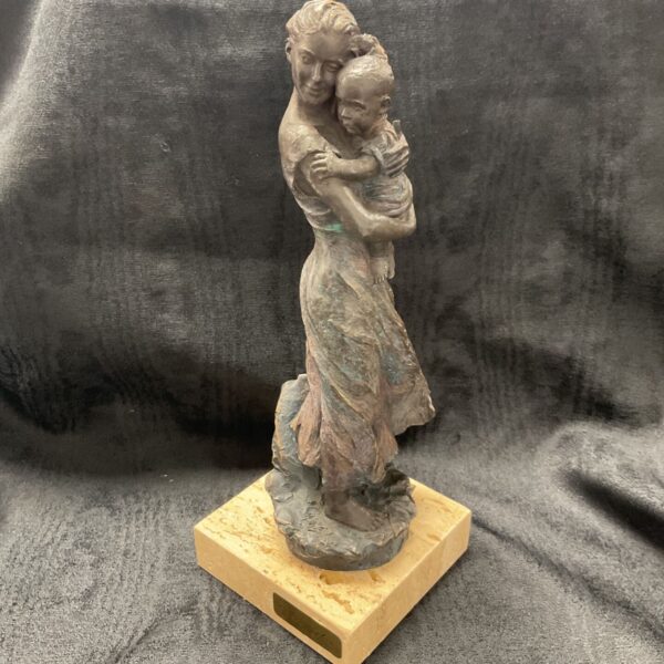 Bronze sculpture of mother and baby on marble base.