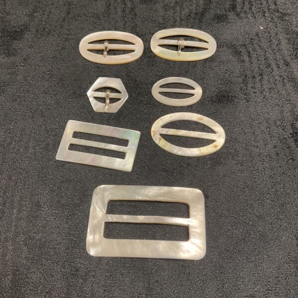 Collection of vintage mother of pearl buckles for crafting.
