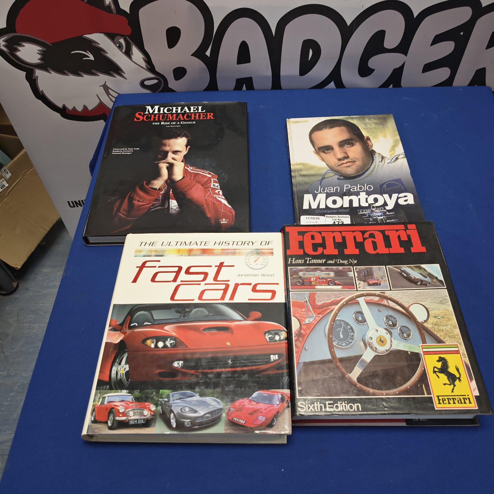 Collection of motorsport books including Ferrari and Michael Schumacher biography.