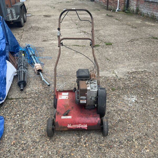 Mountfield petrol scarifier in a garden setting.