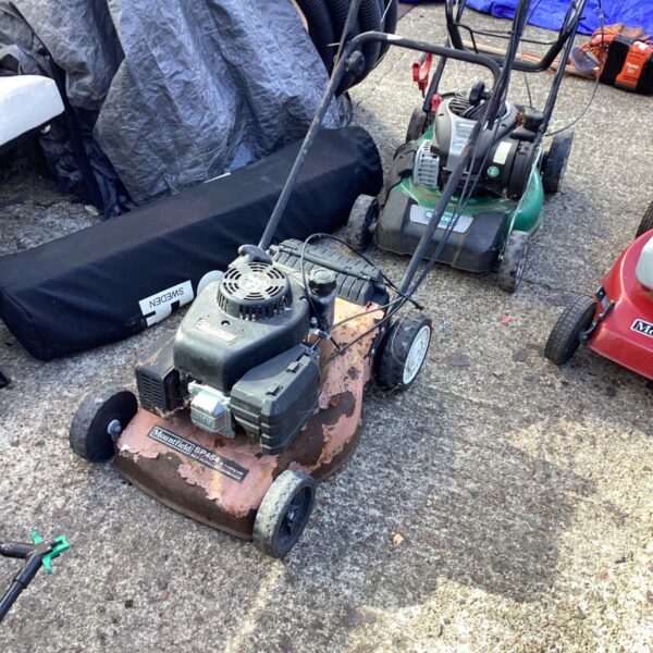 Used Mountfield SP454 petrol lawnmower for garden maintenance.