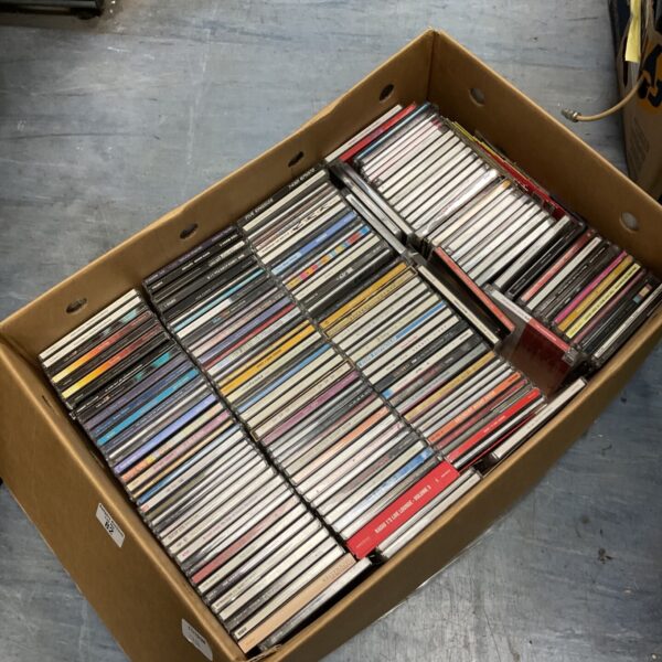 Large box filled with a diverse music CD collection.