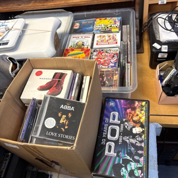 Mixed lot of pop music CDs in boxes.