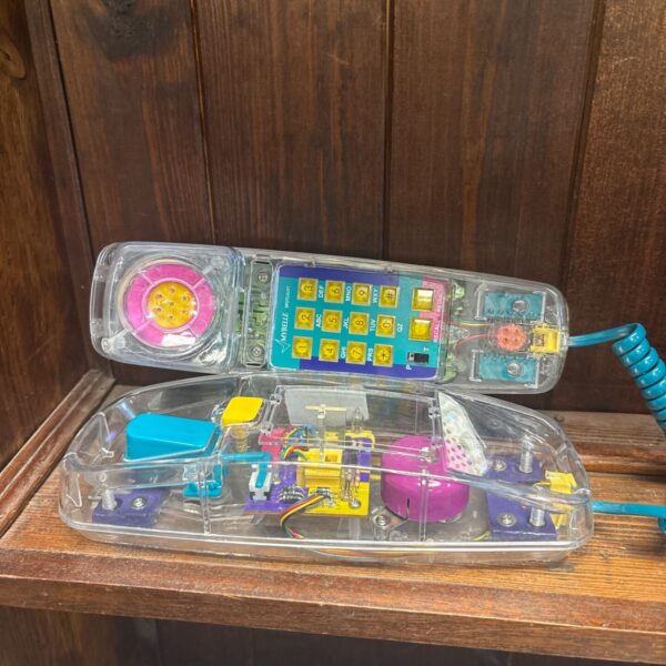 Retro Mybelle Spotlight transparent telephone with visible internals and teal coiled cord