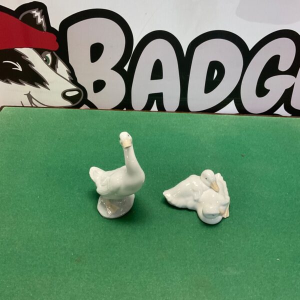 Two vintage Nao porcelain duck figurines, one standing and one resting