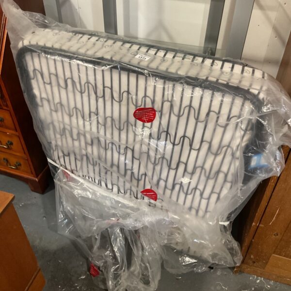 Natural junior mattress wrapped in plastic, white quilted top with grey line pattern