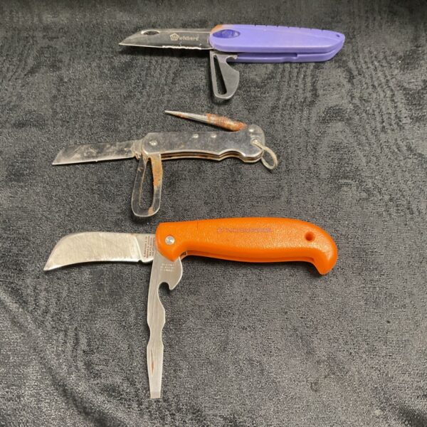 Vintage nautical pocket knives lot with colourful handles.