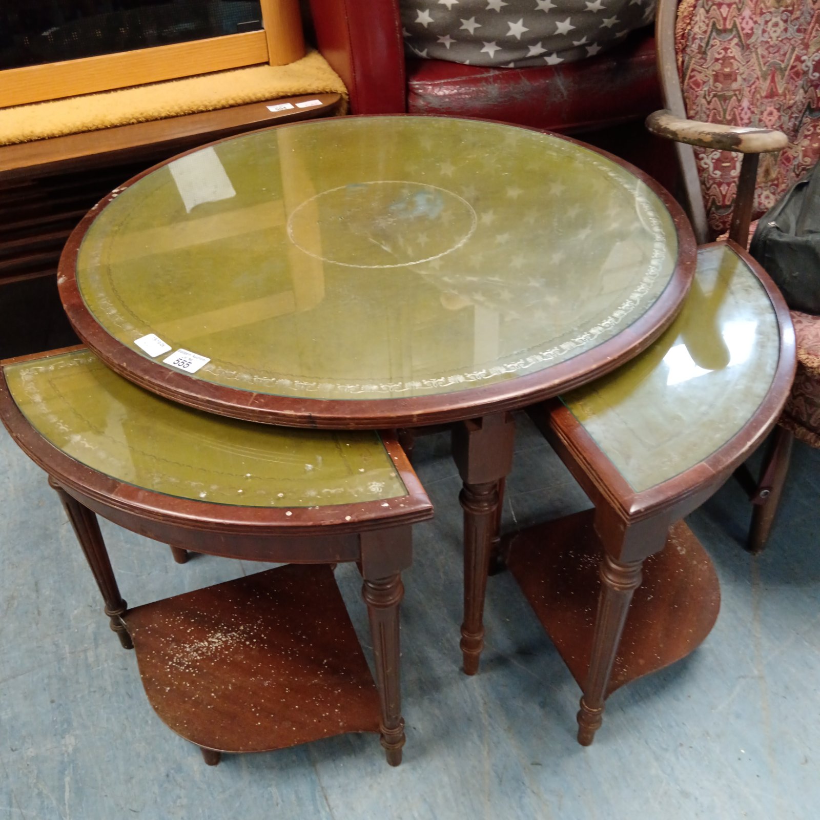 Vintage nest of tables with leather and glass tops.