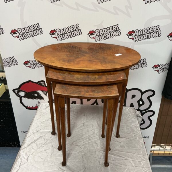 Nest of three yew wood occasional tables with figured tops and tapering legs