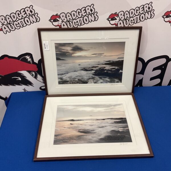 Framed Nick Reader seascape photographs depicting a calm coastal scene.