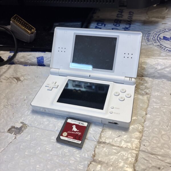 Nintendo DS Lite console with game cartridge presented for auction.