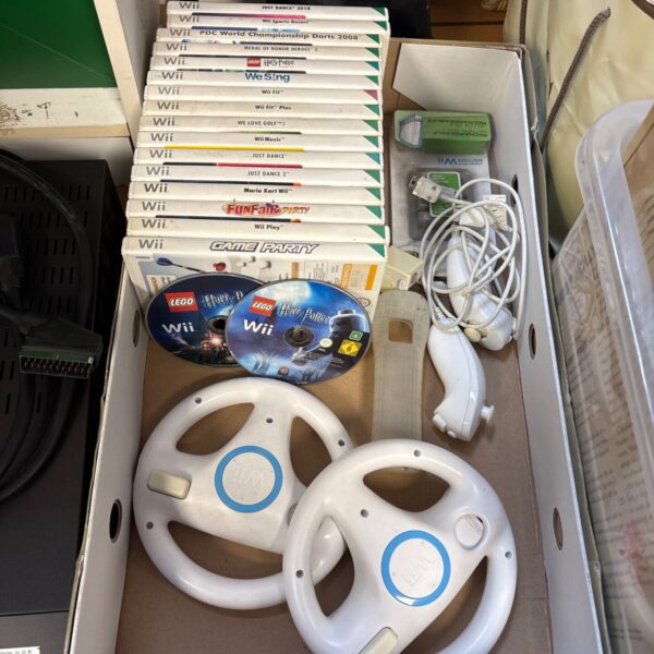 Nintendo Wii bundle with stacked games, steering wheels and controllers