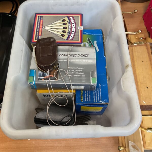 Nokia 3310 accessory pack and vintage phone case in a storage tub.