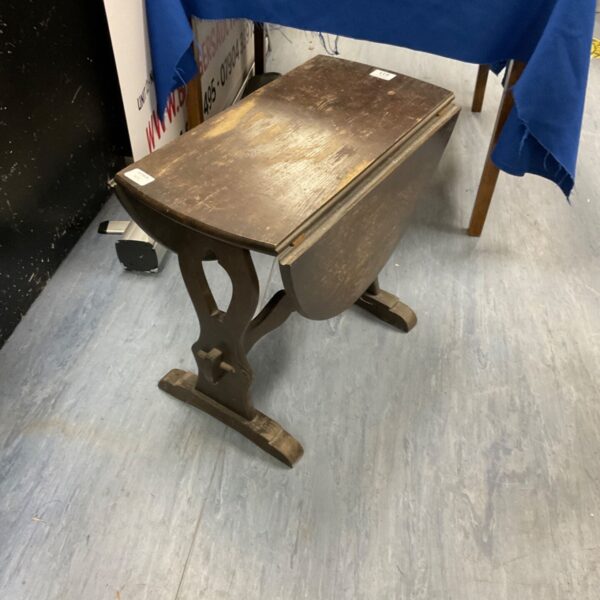 Small antique oak gate leg table with drop leaf design.