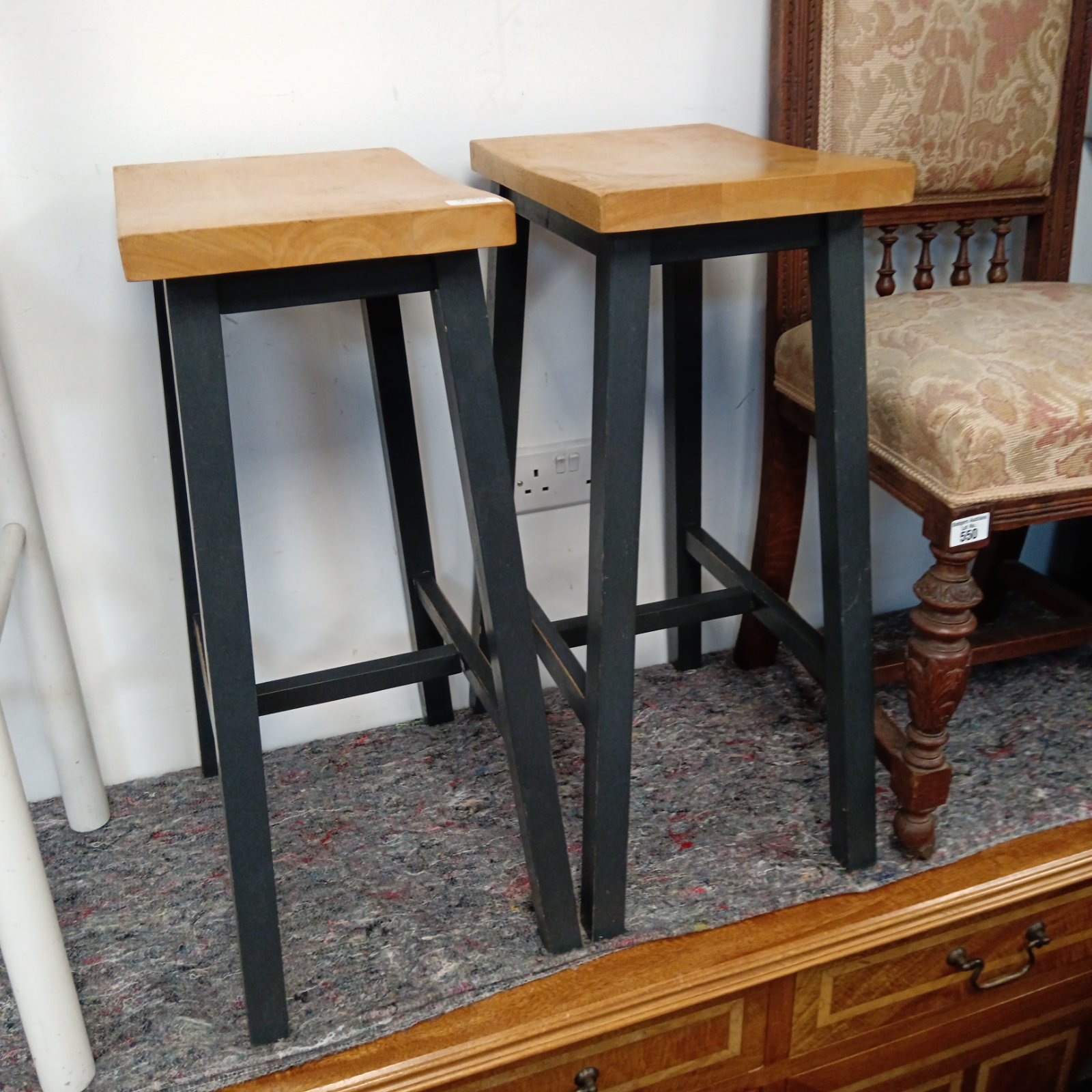 Pair of rustic oak kitchen stools with dark legs.
