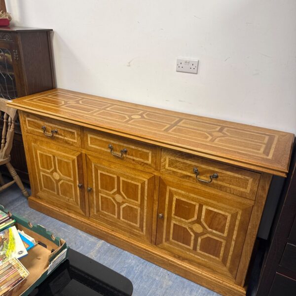 Vintage solid oak sideboard with marquetry detailing for dining room storage.