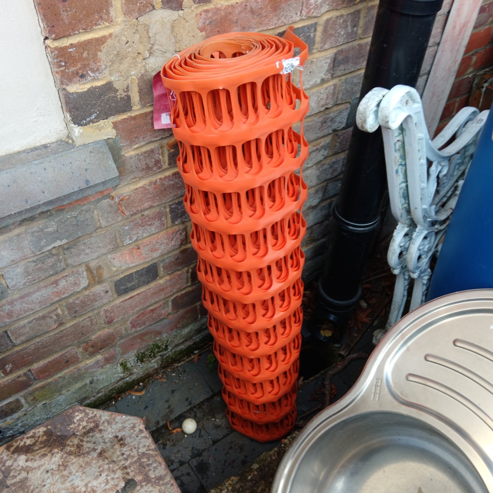 Roll of bright orange safety fencing for temporary barriers.