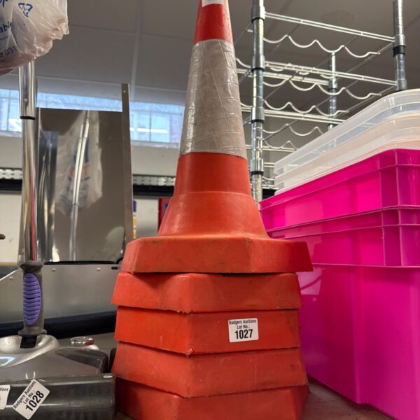 Lot of five orange traffic cones for road safety and hazard marking.