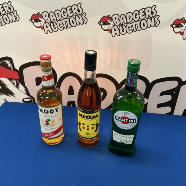 Bottles of Paddy Irish Whiskey, Metaxa, and Martini displayed together.