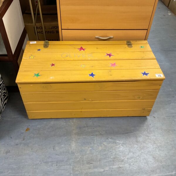 Yellow painted pine toy chest with hand-painted stars and name on lid