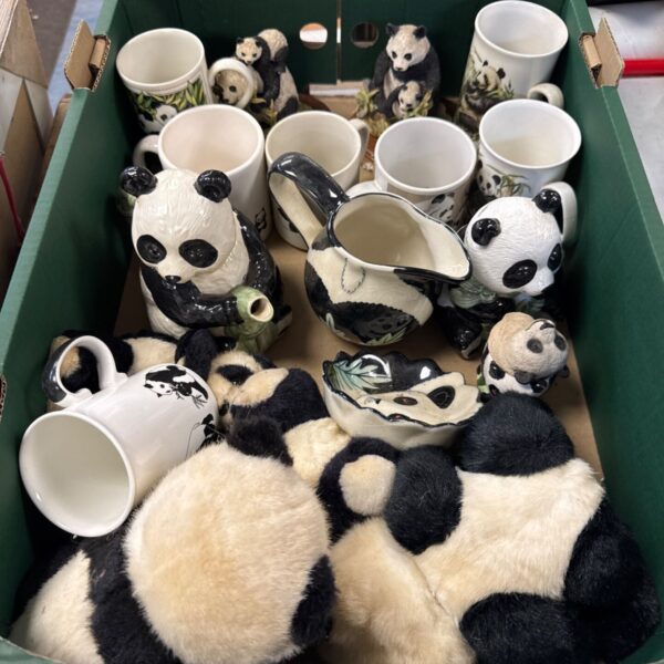Tray of panda themed mugs and ceramic collectibles.