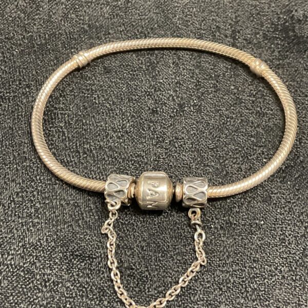 Pandora silver charm bracelet, a classic snake chain design.