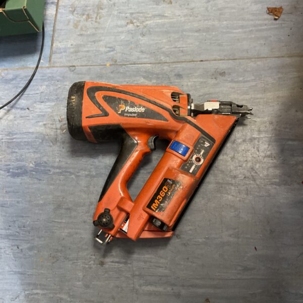 Orange Paslode IM360Ci cordless gas framing nailer on a workshop surface