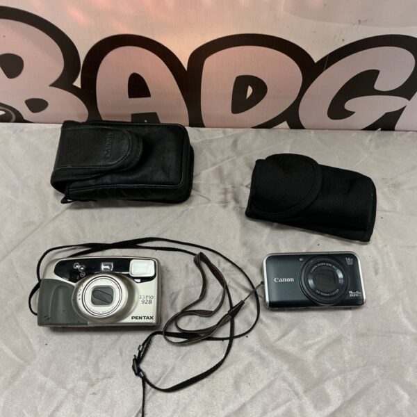 Pentax Espio 928 and Canon PowerShot SX210 IS cameras with black carrying cases