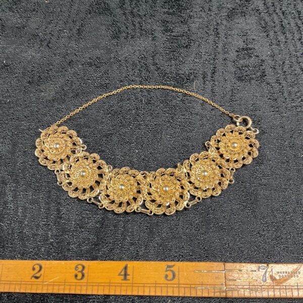 Gilded Persian filigree floral bracelet with six openwork rosette panels