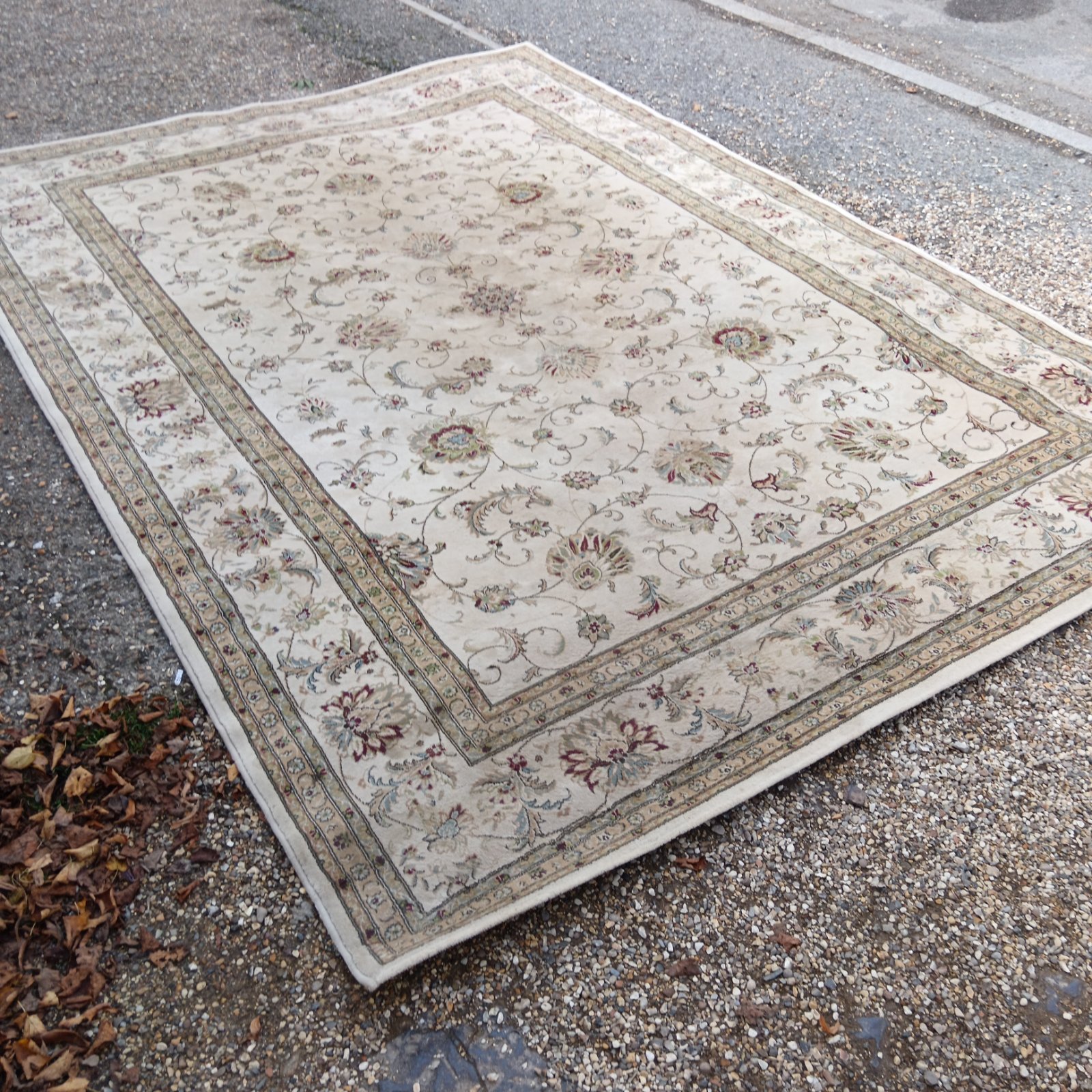 Ivory and beige Persian area rug with floral pattern.