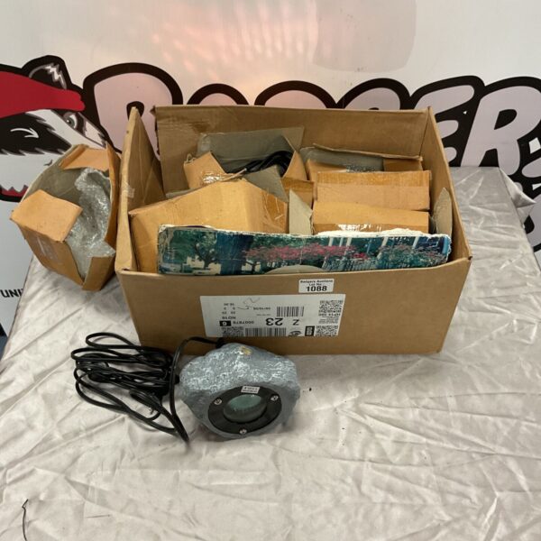 Phase Lighting 12V rock light fitting beside boxed packaging and black cable