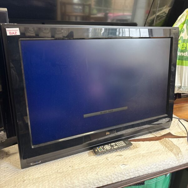 Phillips 32 inch television with remote control and power cable.