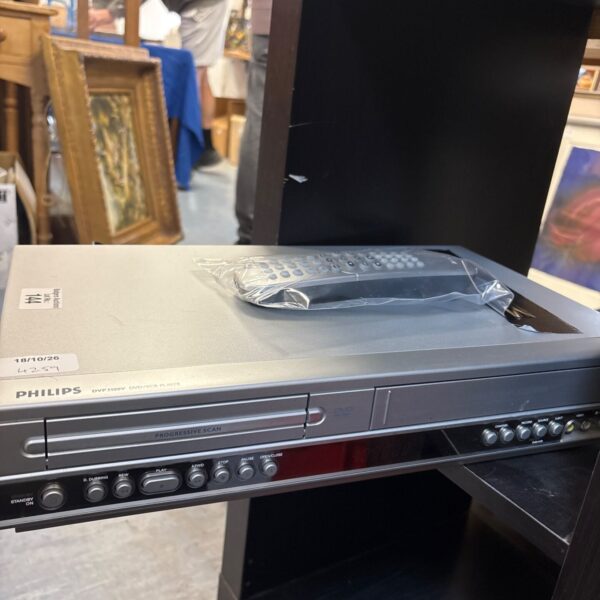Black Phillips DVP310 DVD player with remote control.