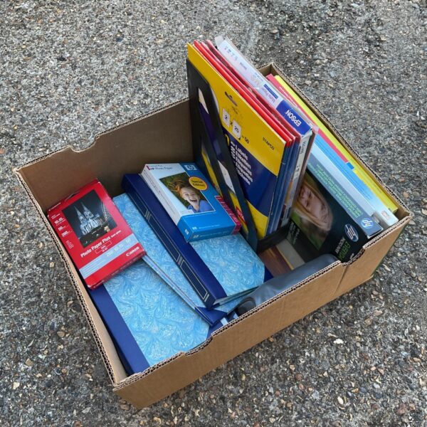 Box of photographic paper and photo albums for vintage photography.