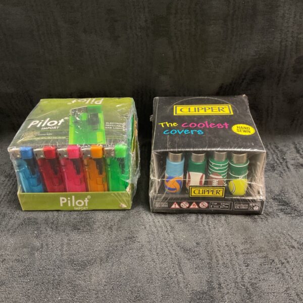 Two sealed packs of Pilot and Clipper gas lighters side by side on a grey surface.