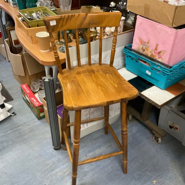 Vintage pine kitchen stool with turned spindles, rustic farmhouse style.