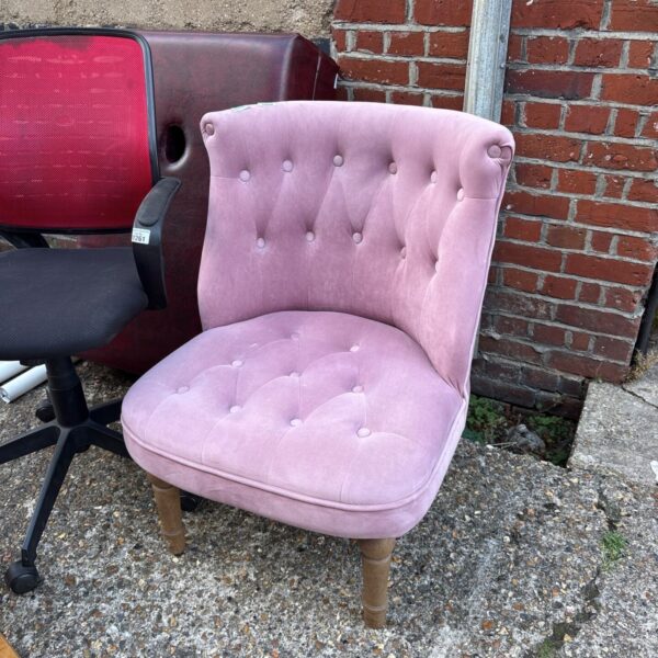 Pink velvet button-tufted accent chair for home decor.