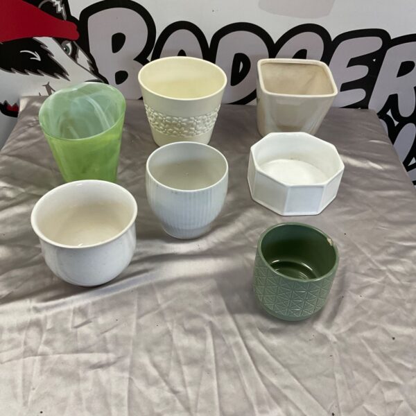 Collection of seven plant pot holders in green, cream and white finishes