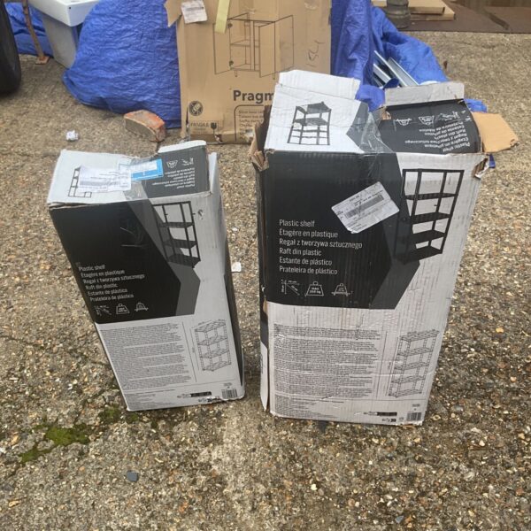 Pair of used plastic shelves for storage.