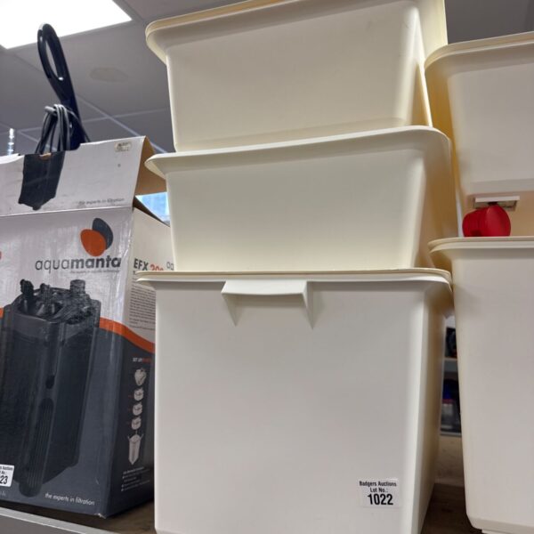 Lot of three plastic storage boxes with lids for household organisation.