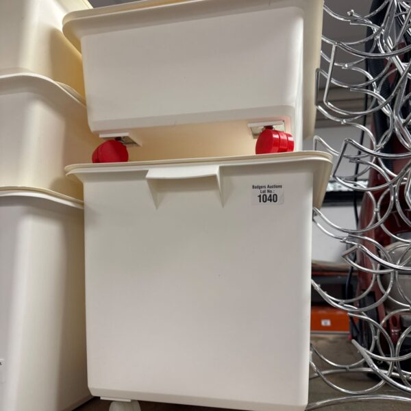 Two wheeled plastic storage tubs with lids for household organisation.