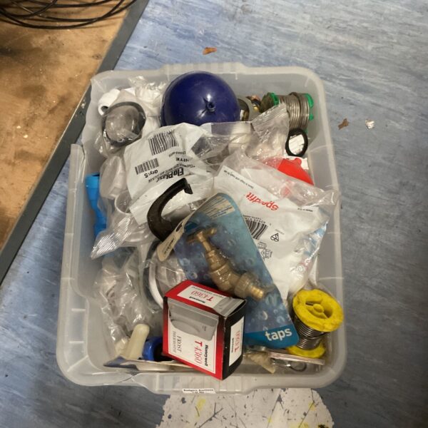 Mixed plumbing and hardware parts lot in a plastic crate, including Honeywell T4360 thermostat