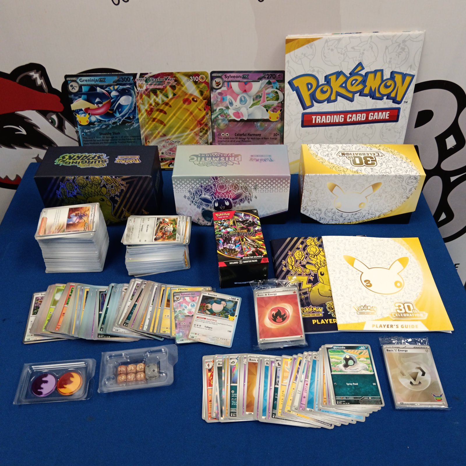 Pokémon card collection with prismatic and 30th anniversary cards.